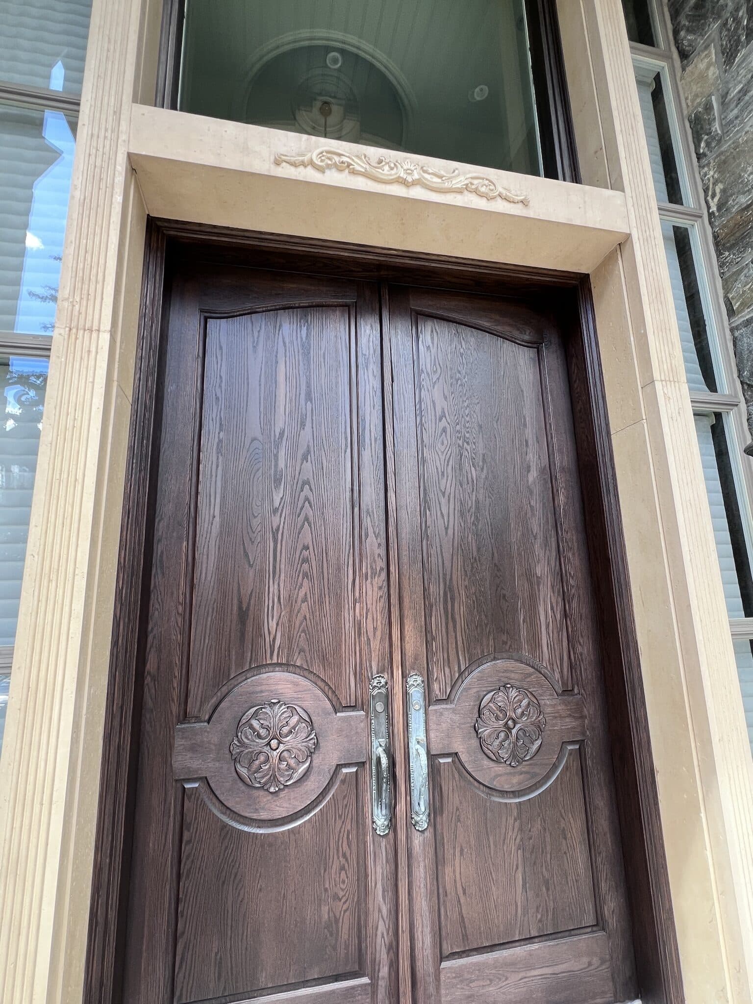 Carved oak double front doors refinished in a rich dark stain