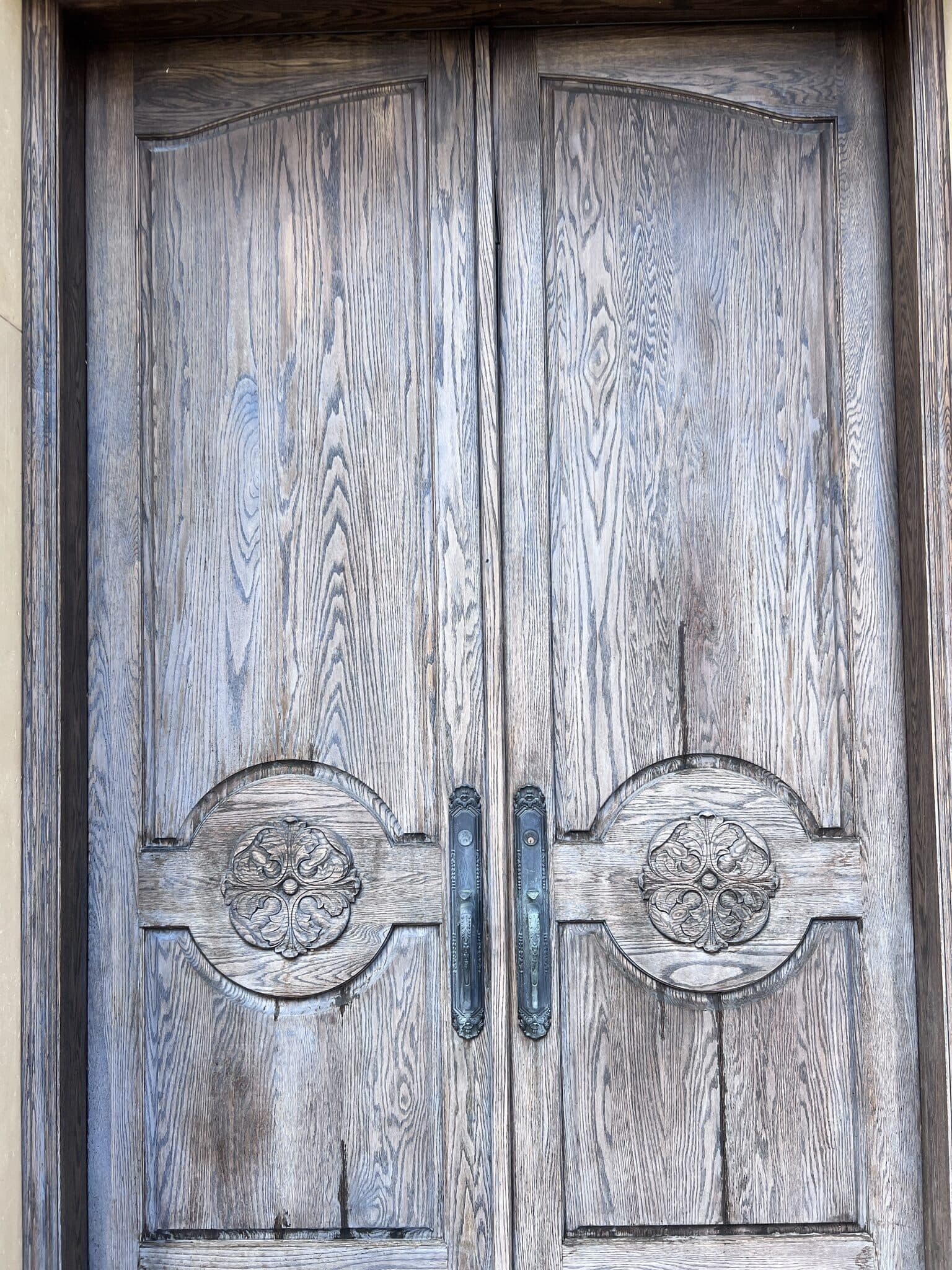Weathered, faded oak double front doors before refinishing